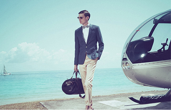 Model with luggage beside a helicopter